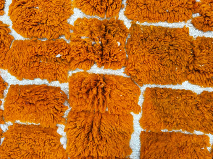 Handmade orange Moroccan runner rug with textured geometric pattern in natural wool, ideal for hallway and modern boho interiors.