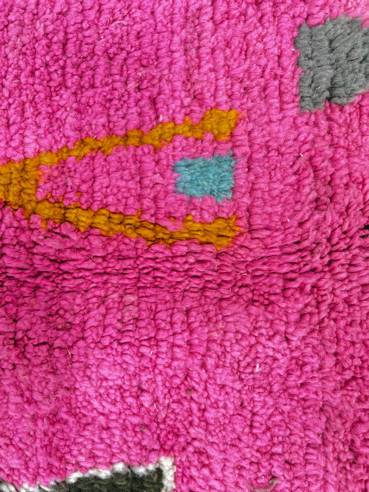 Handmade vibrant pink Moroccan wool runner rug with colorful tribal Berber motifs