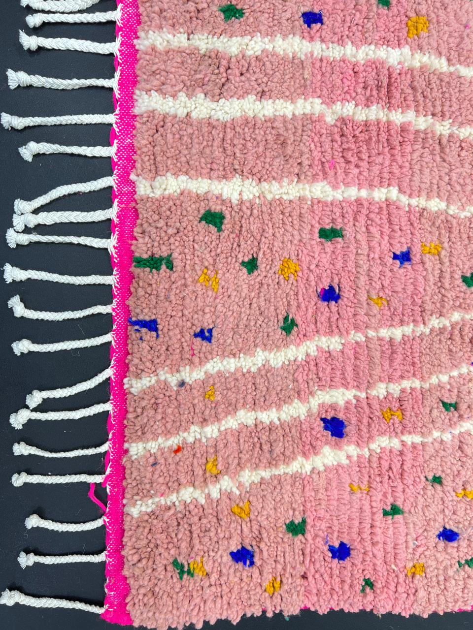 Handmade Moroccan runner rug with vibrant pink background, multicolor dotted accents, and abstract white and blue line design, crafted from natural wool.