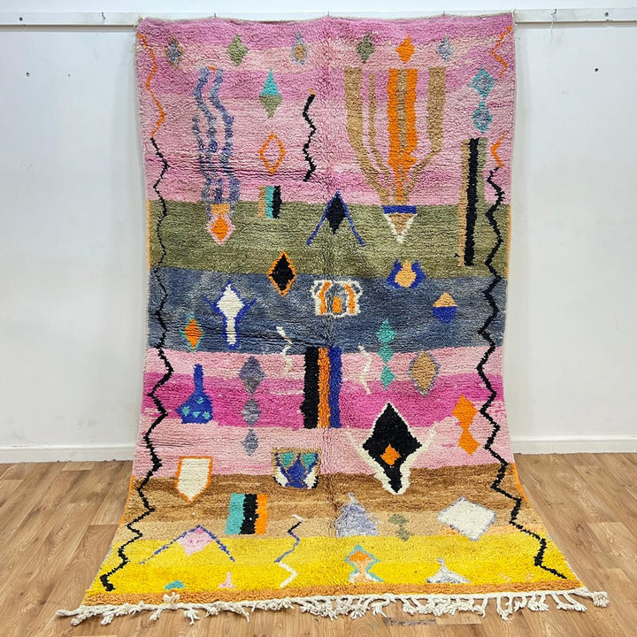 Vintage Moroccan Berber rug with abstract tribal design on pink wool, handmade in Morocco