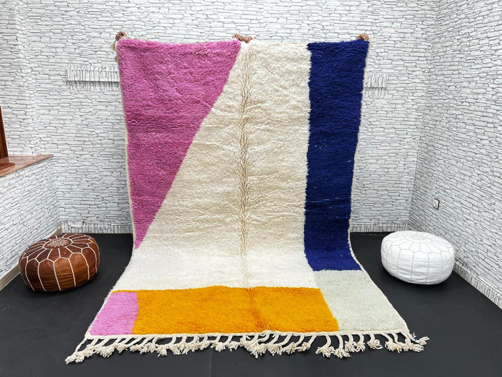 Colorful Moroccan wool rug with pink, blue, and yellow color block abstract design, handmade by Berber artisans