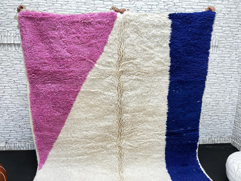 Colorful Moroccan wool rug with pink, blue, and yellow color block abstract design, handmade by Berber artisans