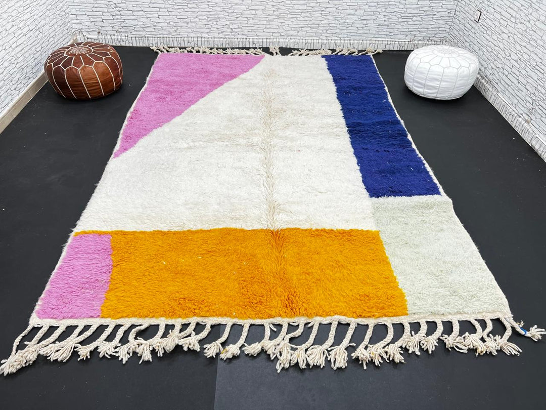 Colorful Moroccan wool rug with pink, blue, and yellow color block abstract design, handmade by Berber artisans