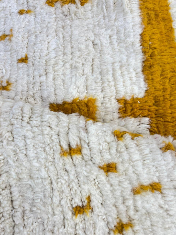 white moroccan wool rug with yellow berber geometric symbols handmade
