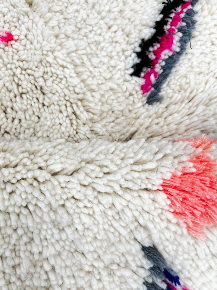 Handmade white Moroccan wool runner rug with colorful Berber symbols and modern geometric motifs