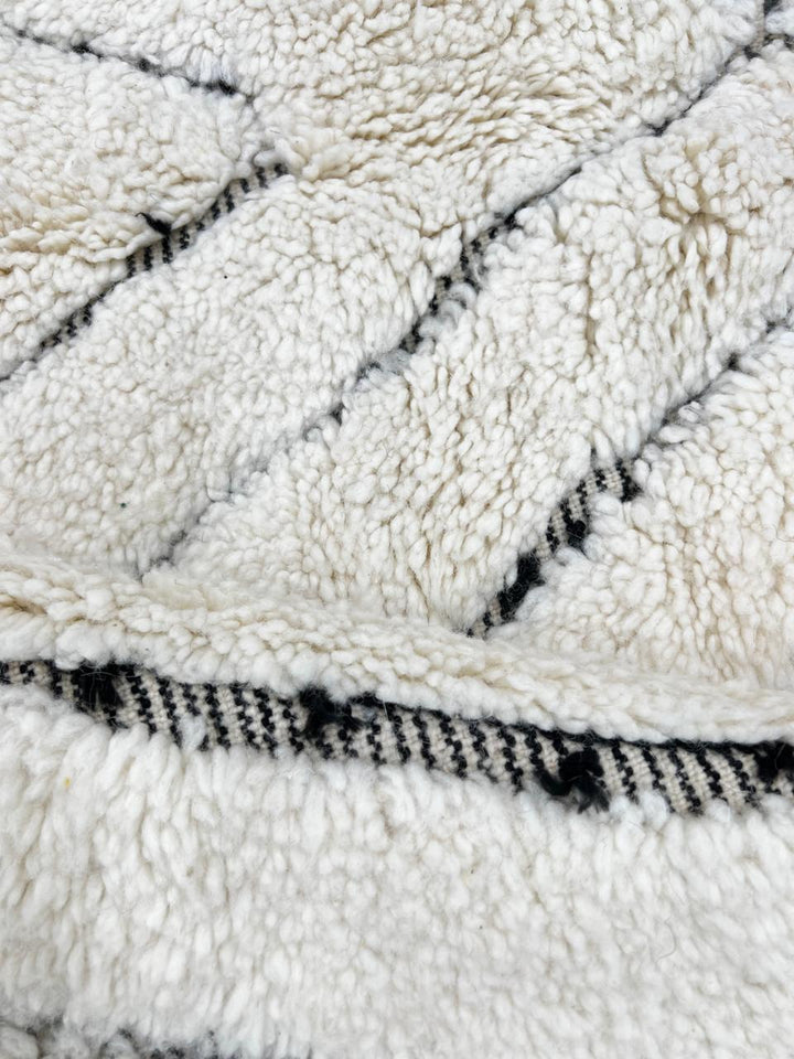 Handmade white Beni Ourain Moroccan runner rug with minimalist diamond line pattern in natural wool.