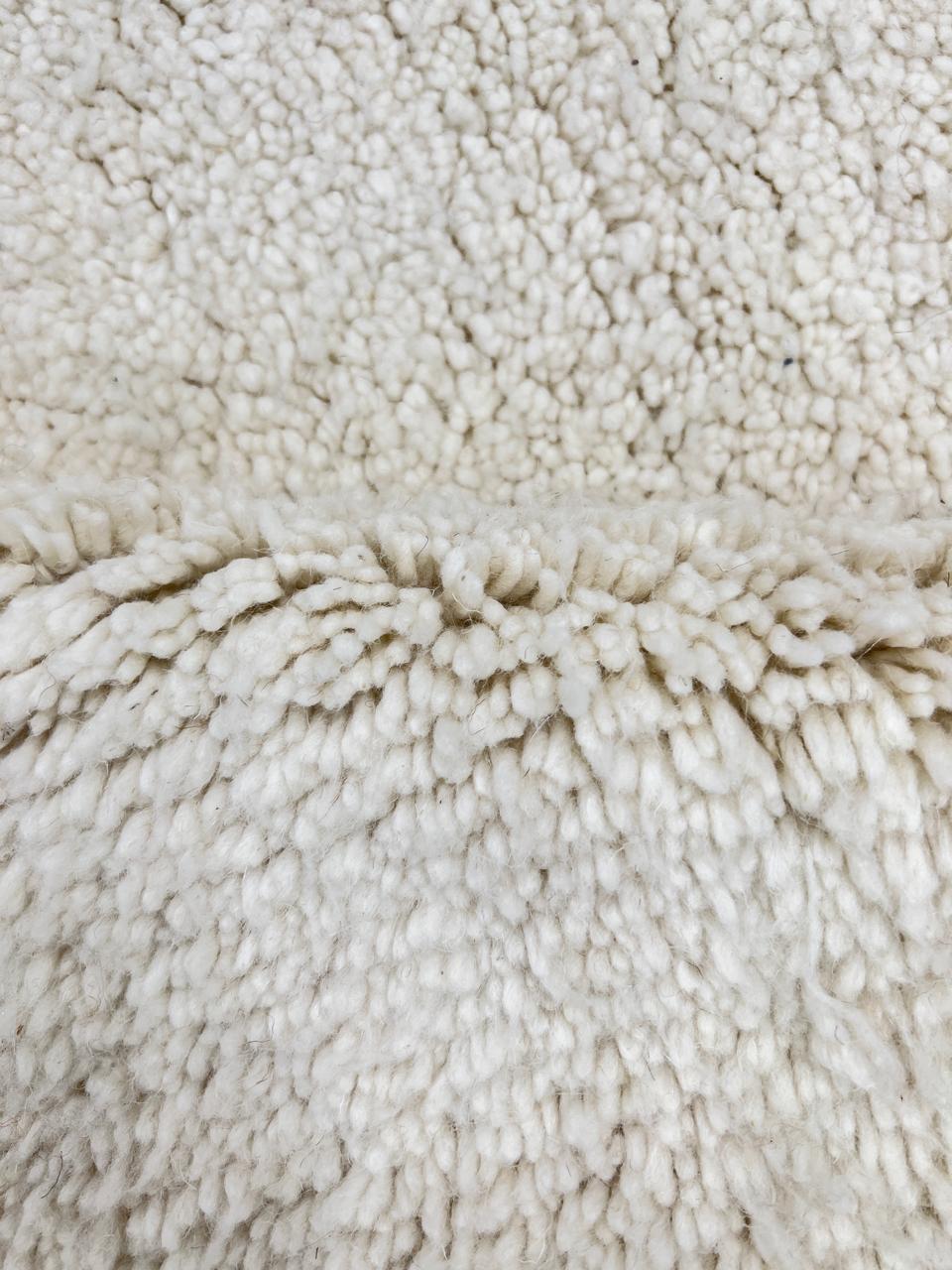 Handmade Moroccan runner rug in solid white natural wool with minimalist tassels, crafted by Berber artisans.