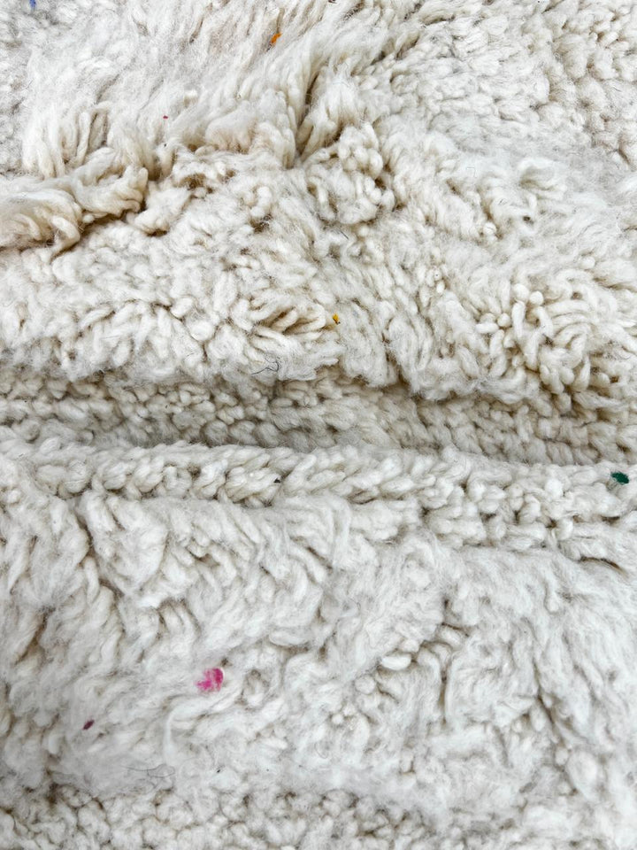 Handmade white Moroccan runner rug with subtle carved chevron texture in natural wool.