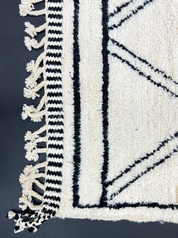 White and black handmade Moroccan wool runner rug with diamond geometric design