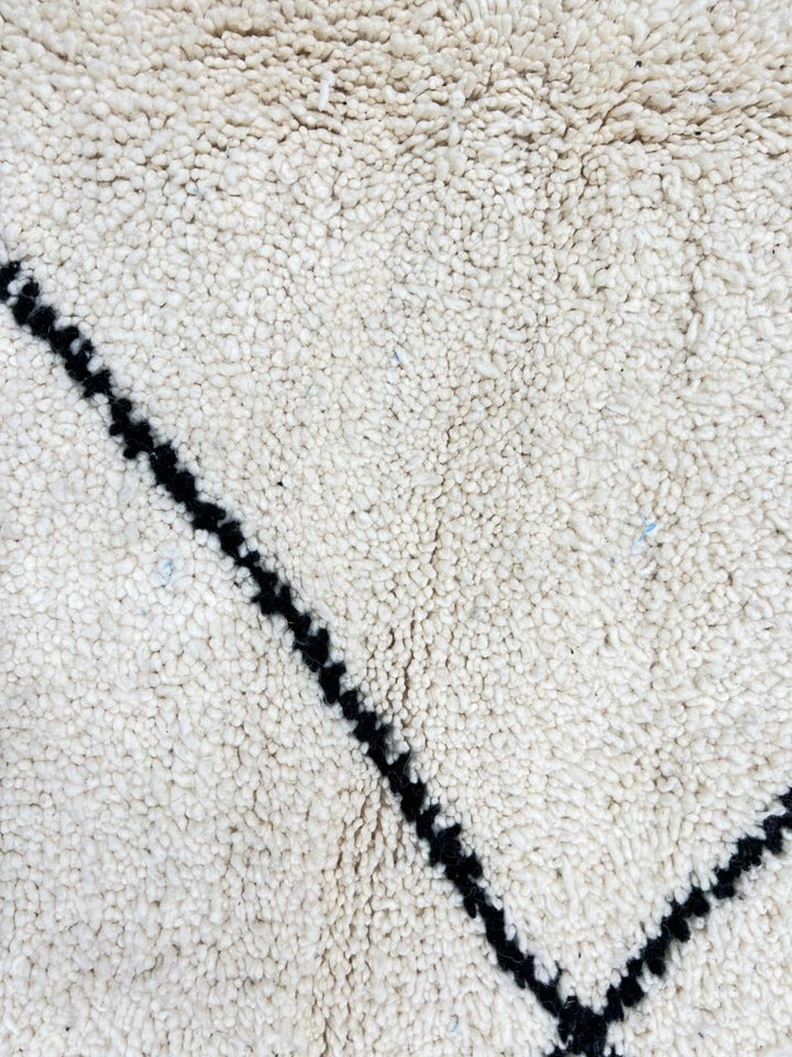 Handmade Moroccan wool runner rug in white with black diamond-line design, Beni Ourain style