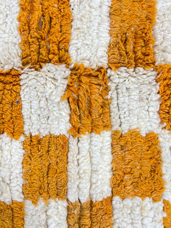 Handwoven Moroccan wool rug with yellow and cream checkered pattern