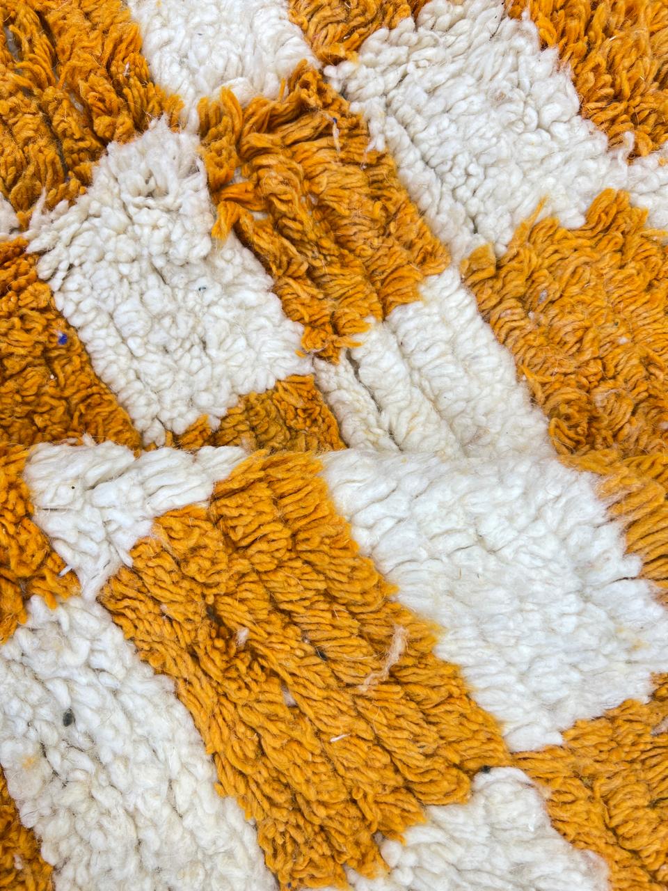 Handwoven Moroccan wool rug with yellow and cream checkered pattern