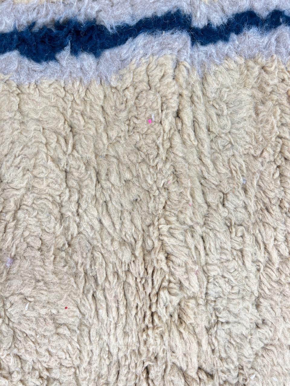 Handmade yellow Moroccan wool rug with blue border, soft plush Beni Mrirt design