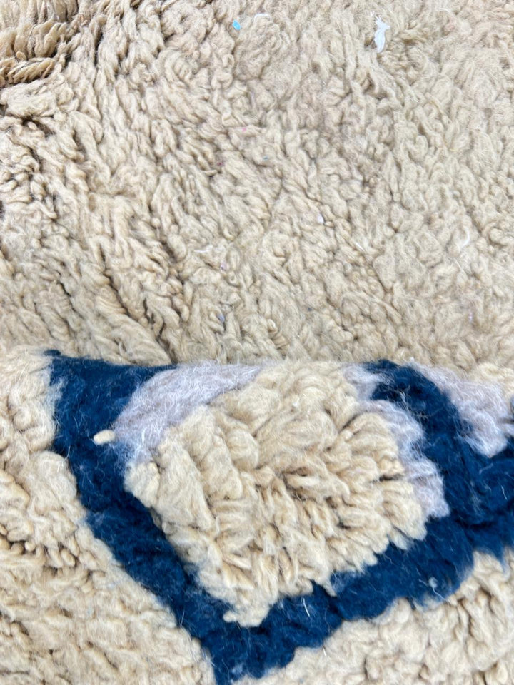 Handmade yellow Moroccan wool rug with blue border, soft plush Beni Mrirt design