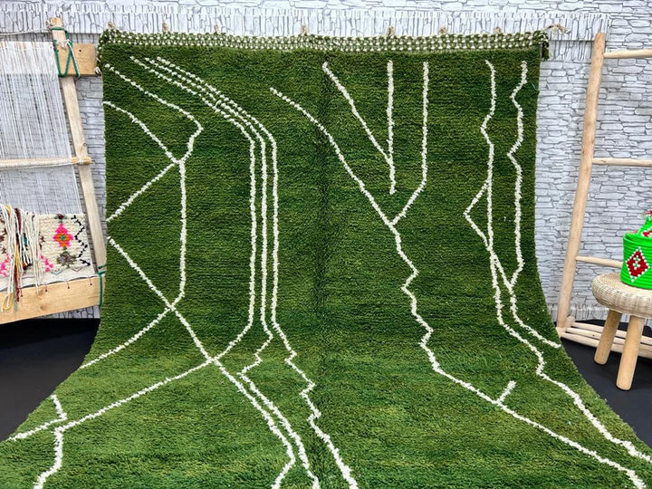 Green Beni Mrirt Moroccan Berber rug with white geometric patterns, handmade from Moroccan wool, displayed in a room setting.