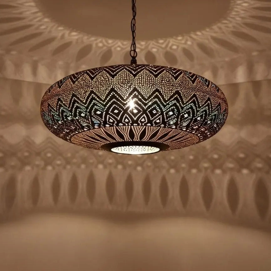 Decorative pendant light casting shadows on a textured wall